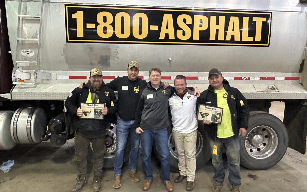 488180384_1244685130996395_1151522181050014768_n Five men stand in front of a large truck with a sign reading 1-800-ASPHALT. Two on the left hold certificates, and all are smiling, posing for the photo in an ohio paving and construction workshop or garage setting.